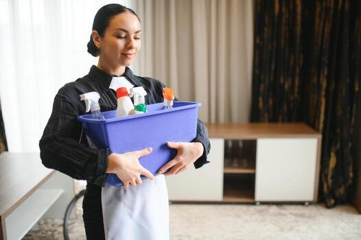 housekeeper-or-maid-cleaning-hotel-room-photo.jpg
